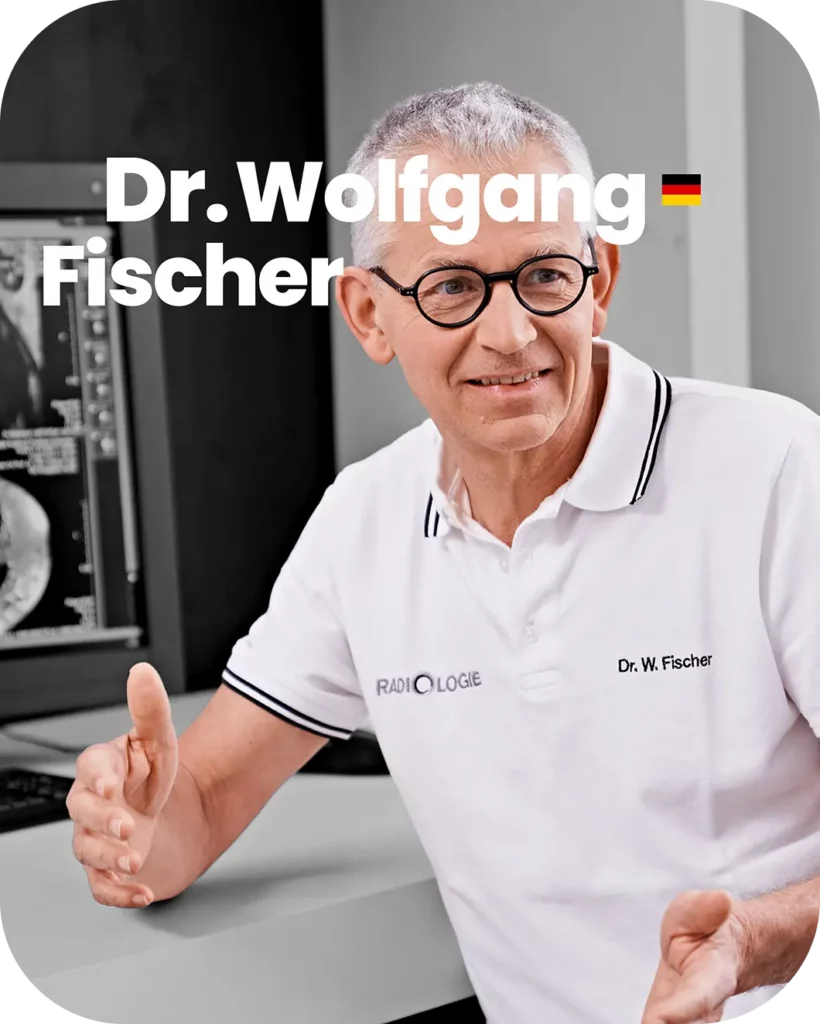 Portrait image of Dr. Wolfgang Fischer in front of an mri medical monitor
